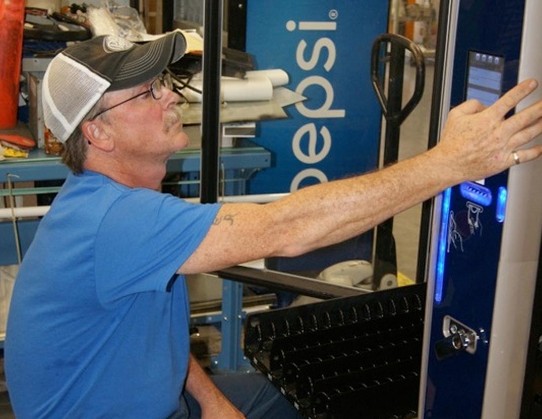 man working on vending machine