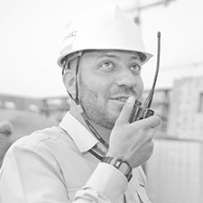 man with hard hat talking into radio